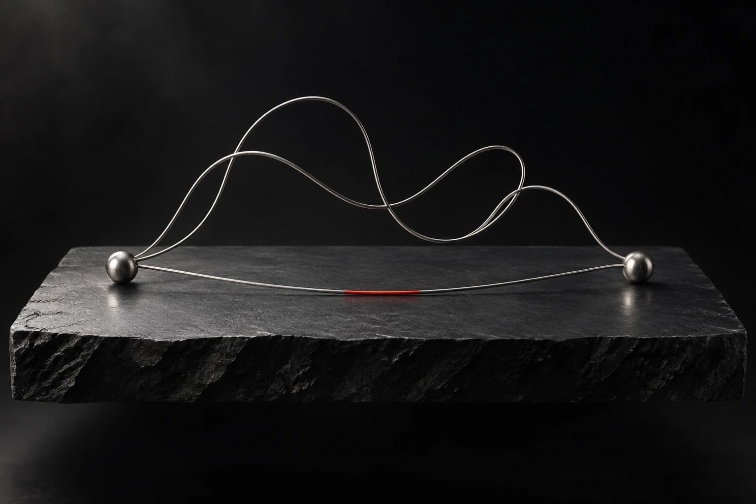 Curving silver filaments and a direct red-accented filament connect two metal anchors on a graphite surface